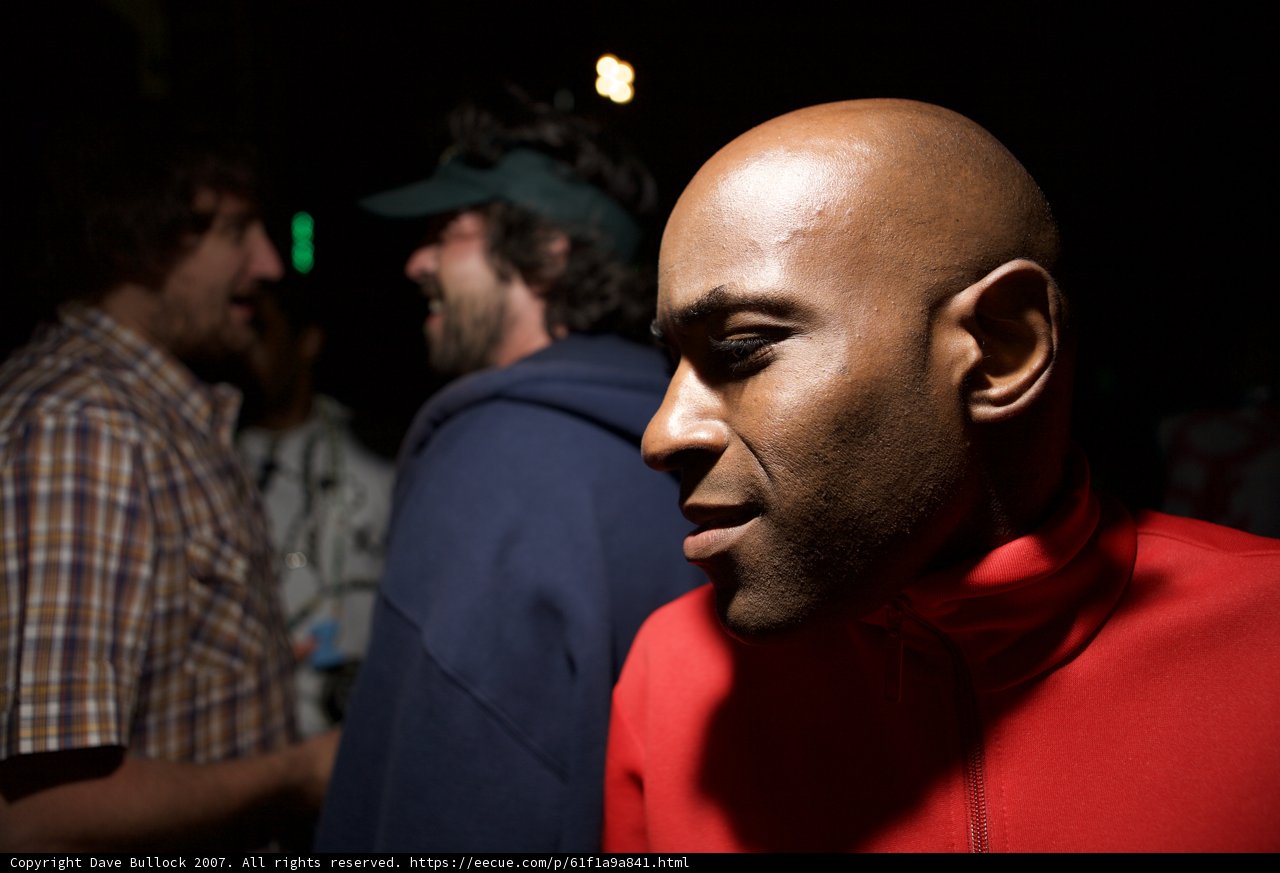 Bald man in a red shirt with his crew