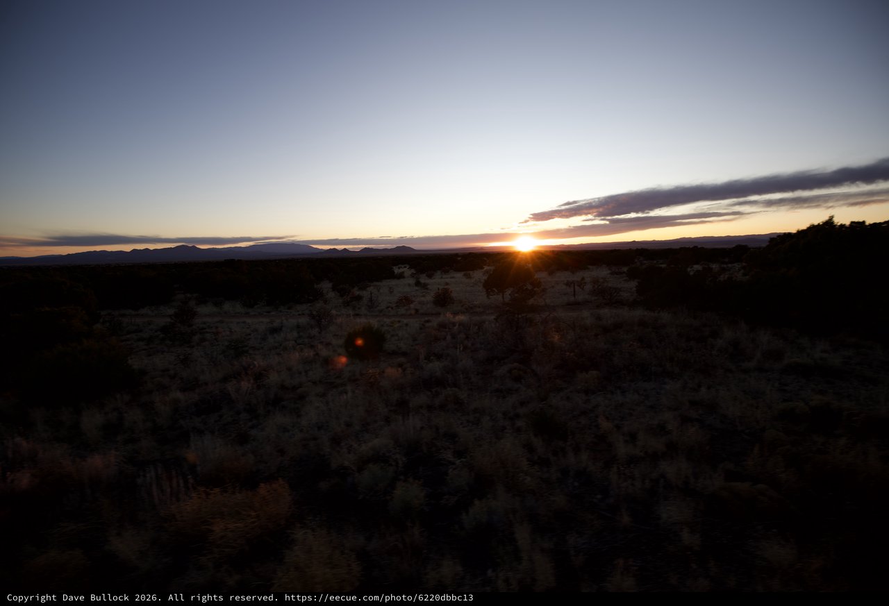 Desert Sunset Over Distant Mountain Range