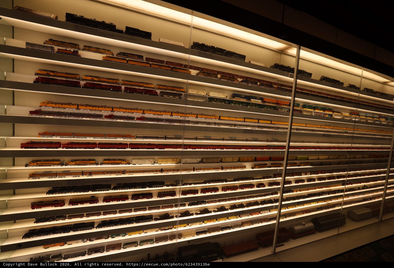 Extensive Model Train Collection Display with Illuminated Shelving