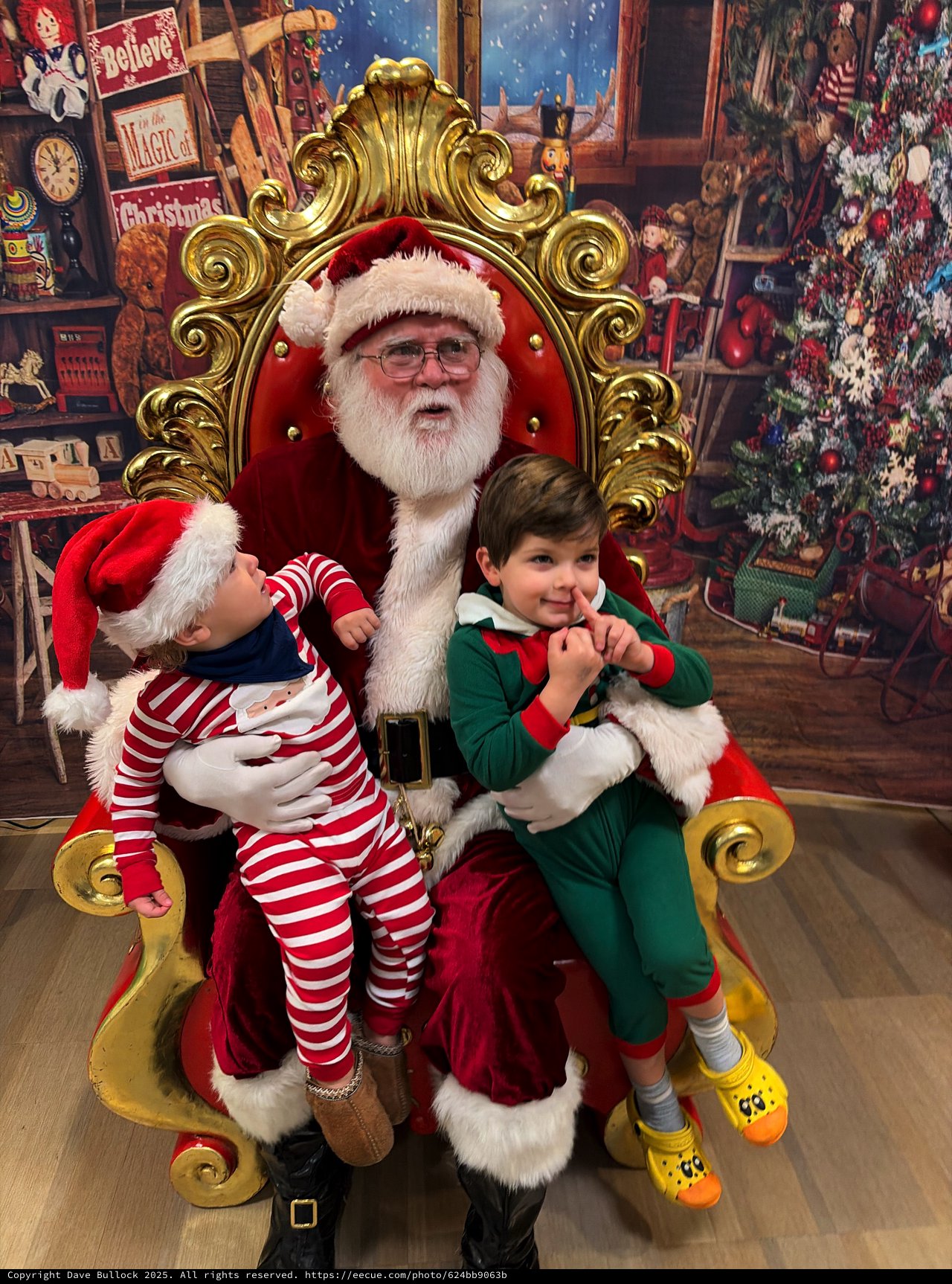 Two Children Visit Santa in His Workshop Grotto