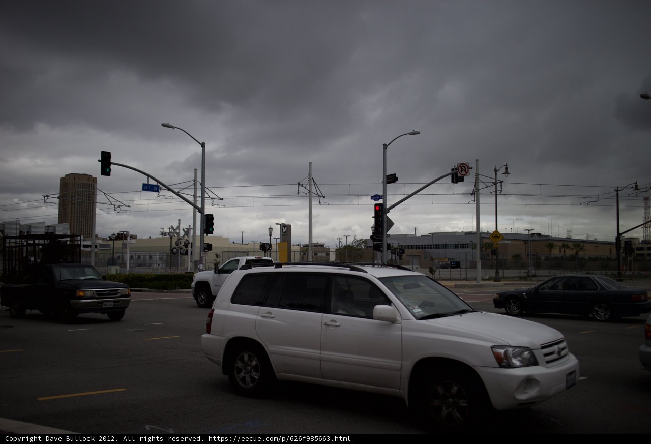 SUV on a Cloudy Urban Road Intersection
