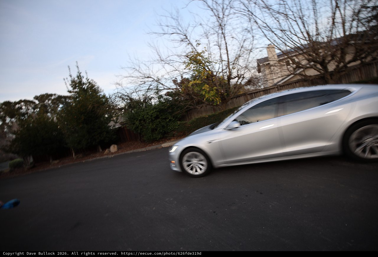 Silver Sedan in Motion at Dusk