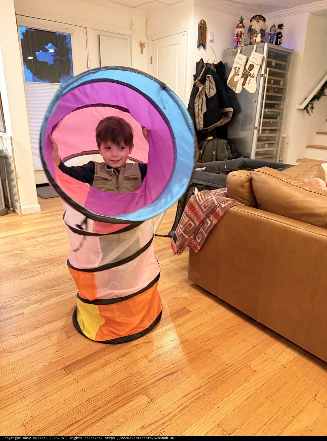 Child Playing in Colorful Pop-Up Tunnel at Home