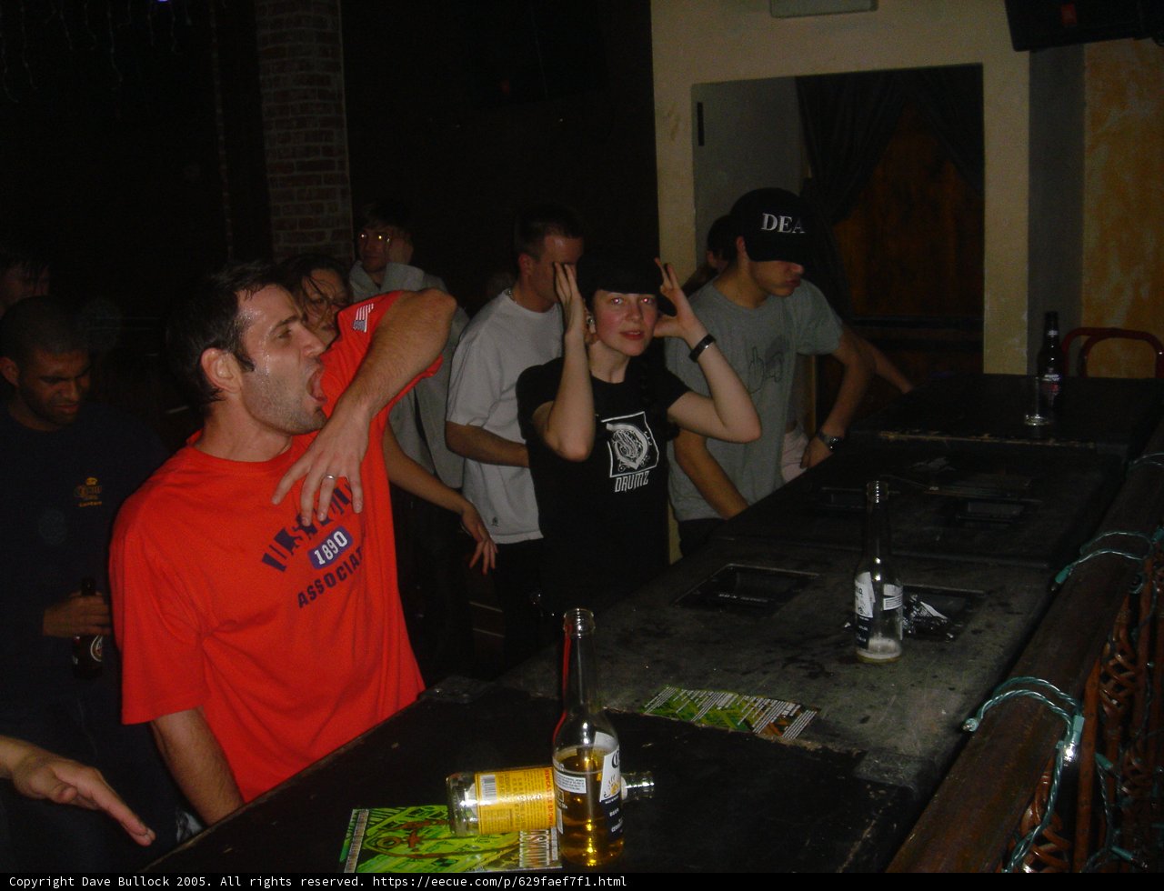 Red-Shirted Man Enjoying a Night Out at the Bar