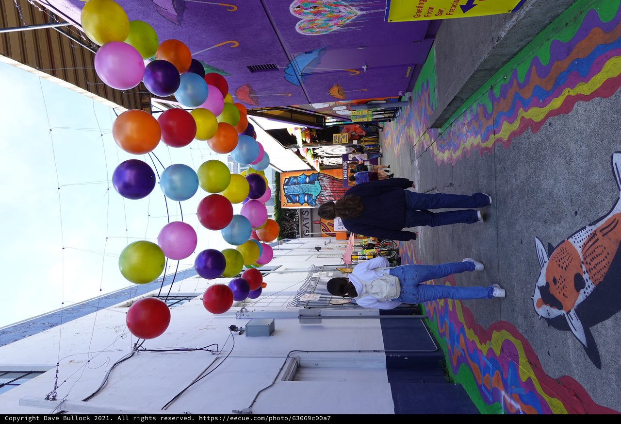 Colorful Balloon Installation in Vibrant Street Alley
