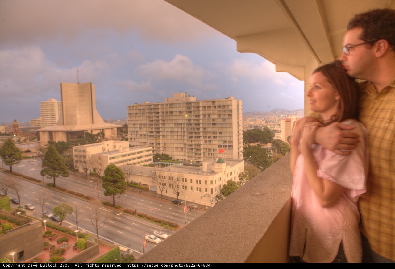 Couple Gazing Over San Francisco From Hotel Balcony