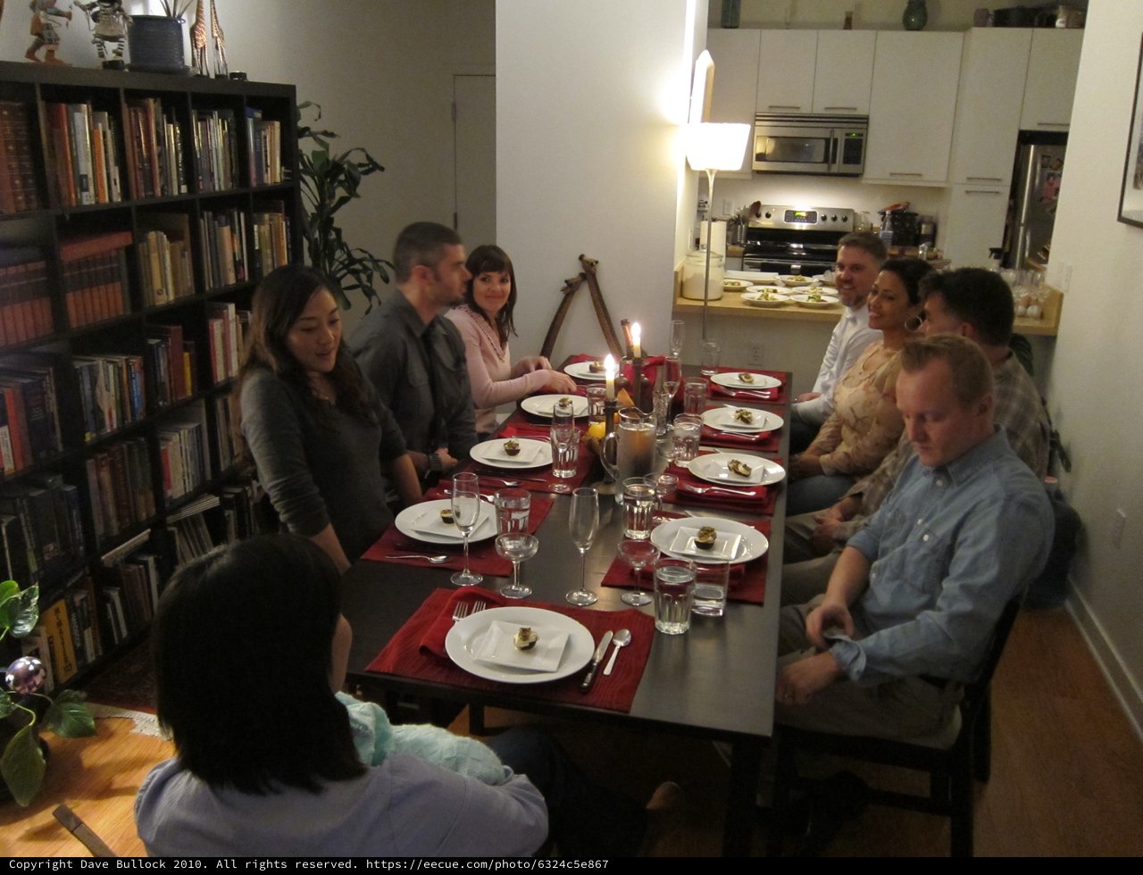 Intimate Hanukkah Dinner Party with Friends Around Table