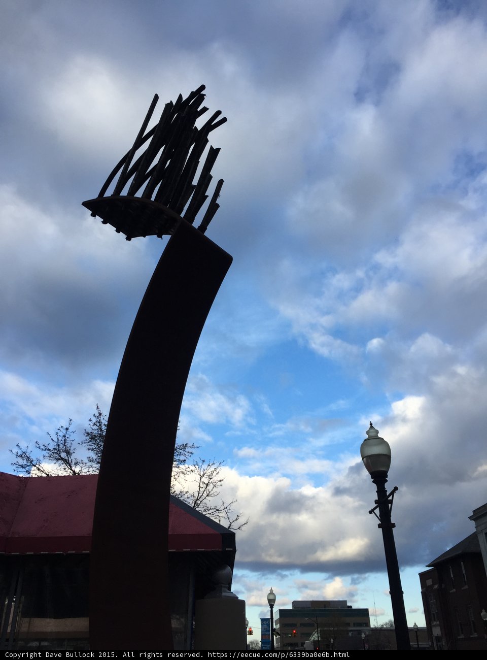 Bird perched before architecture silhouette