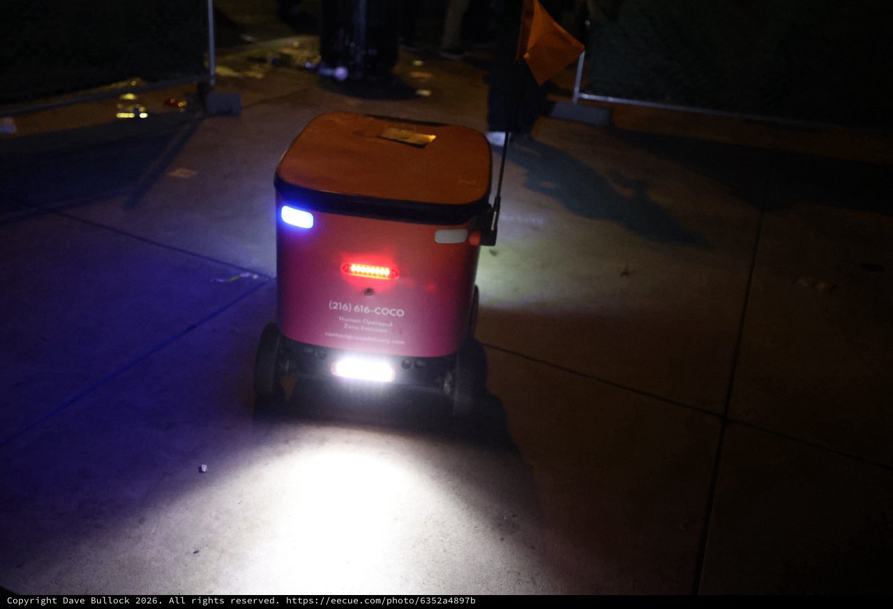 Coco Delivery Robot Glows on Nighttime Sidewalk
