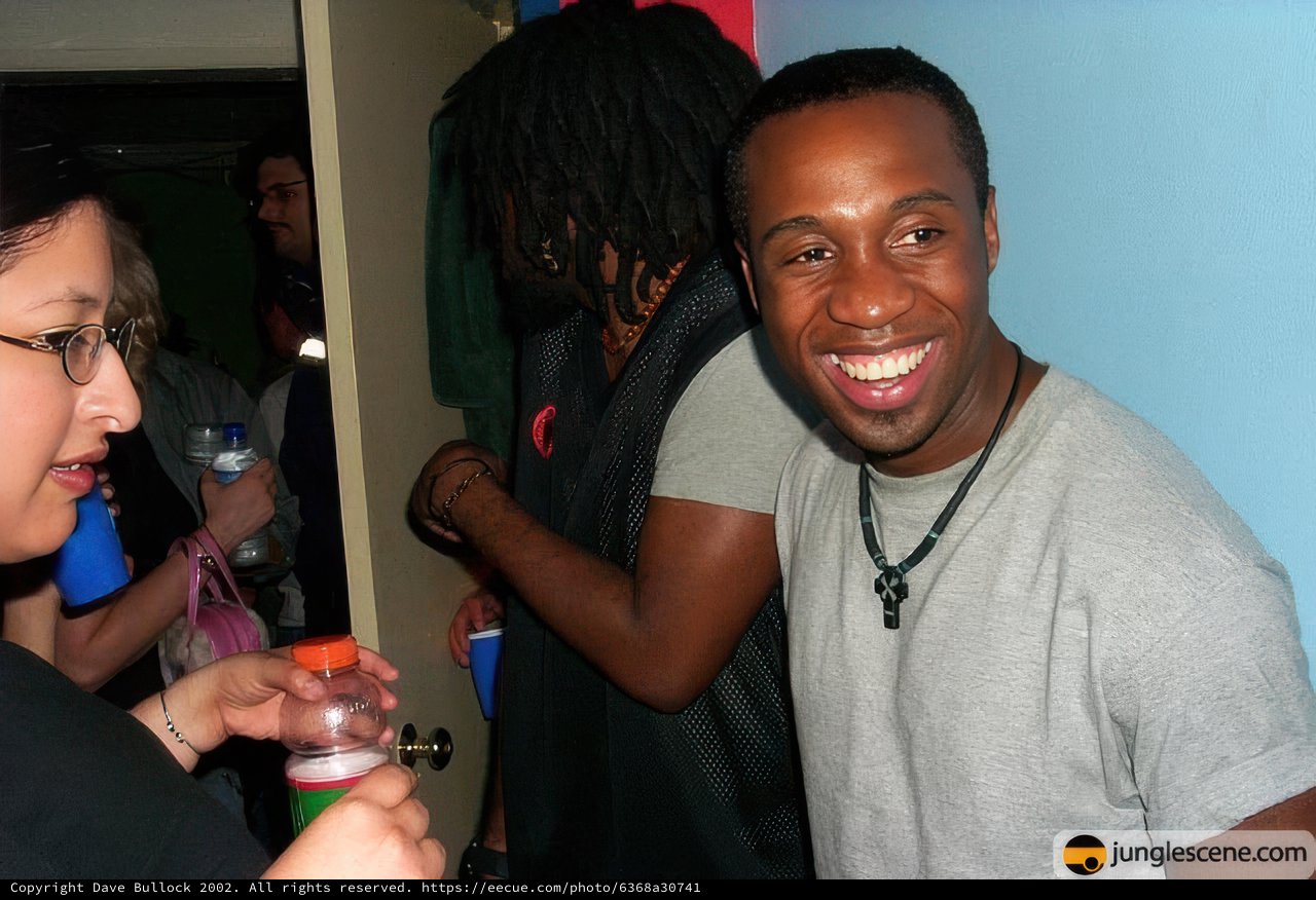 Smiling Man Enjoying Drink with Friends
