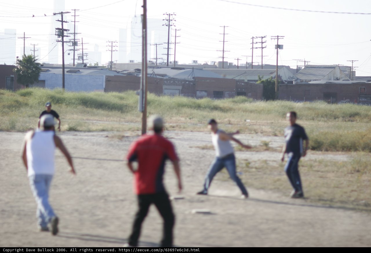 Group Baseball Game in Dirt Field