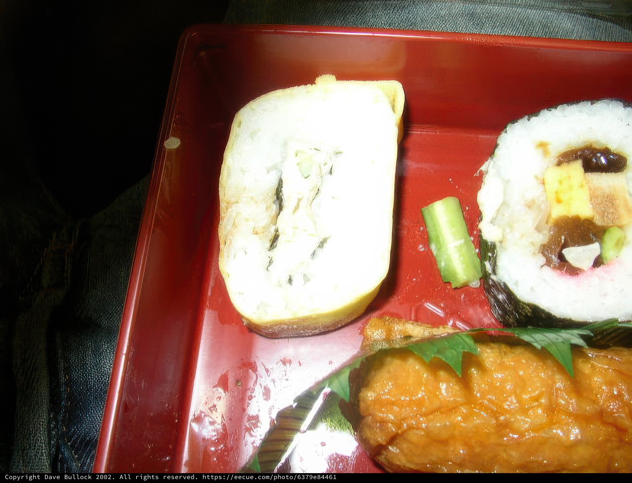 A Colorful Sushi Roll on a Vibrant Red Tray