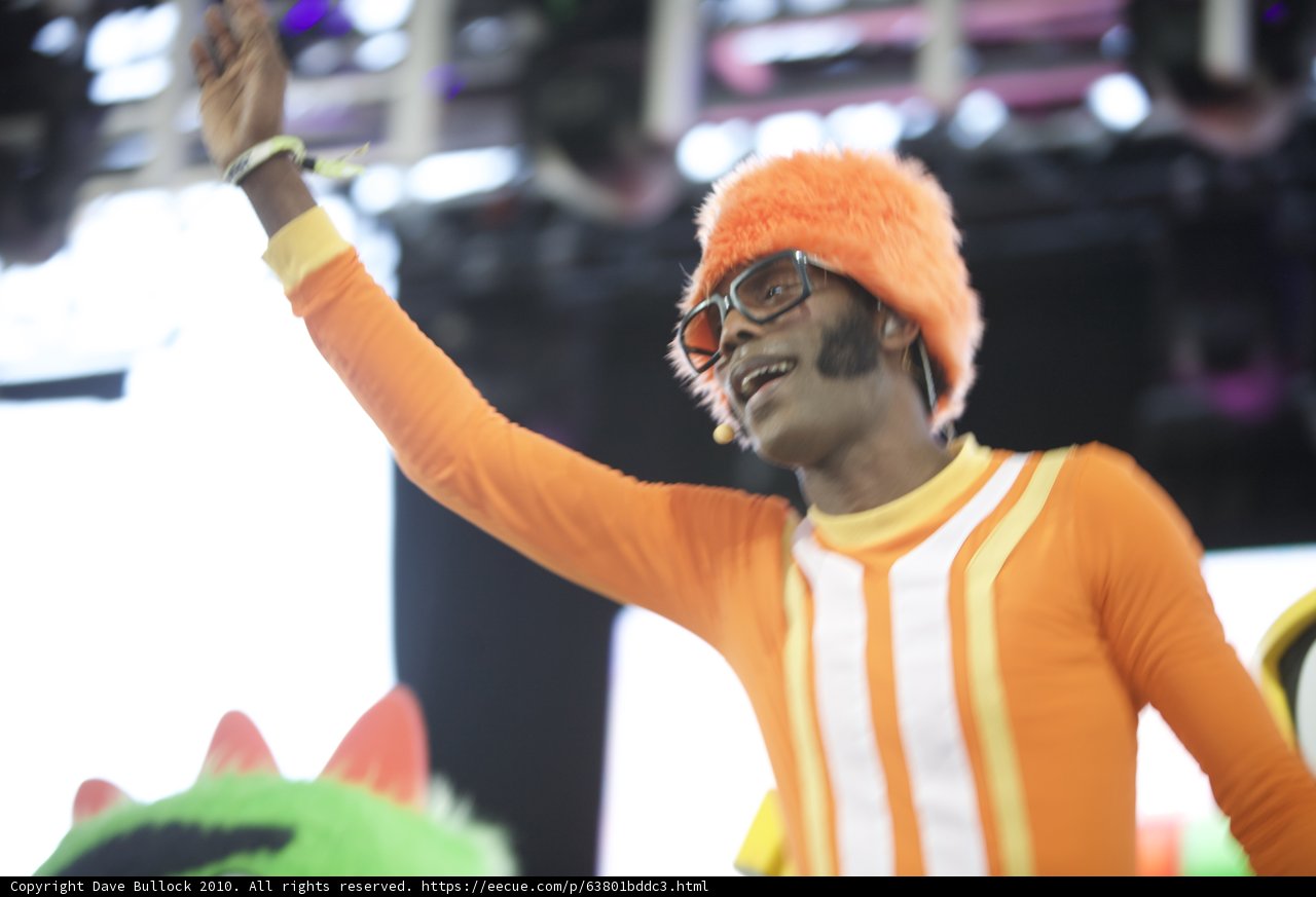 Orange Man Waves to Crowd