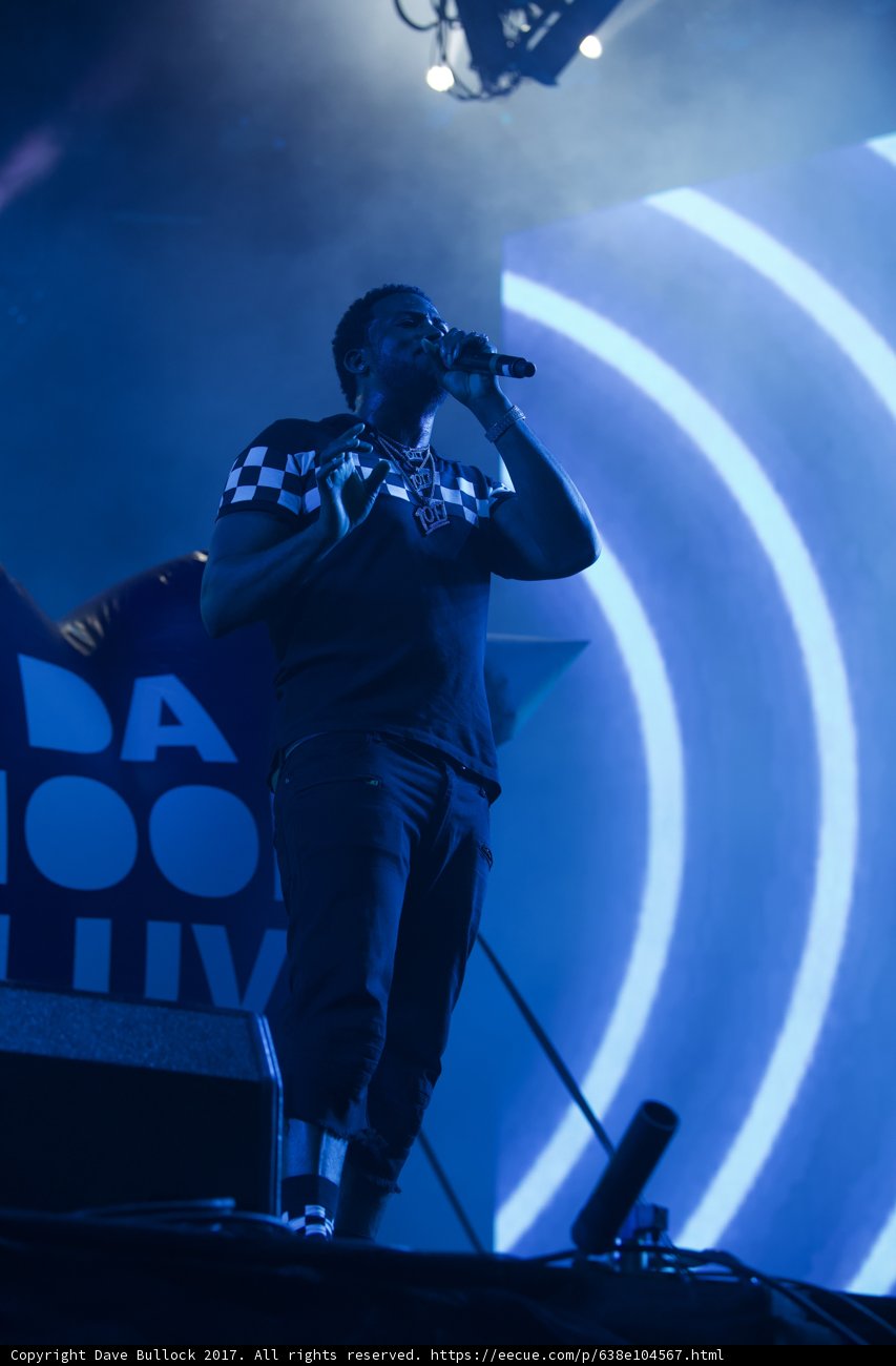 Man on Stage with Three Microphones