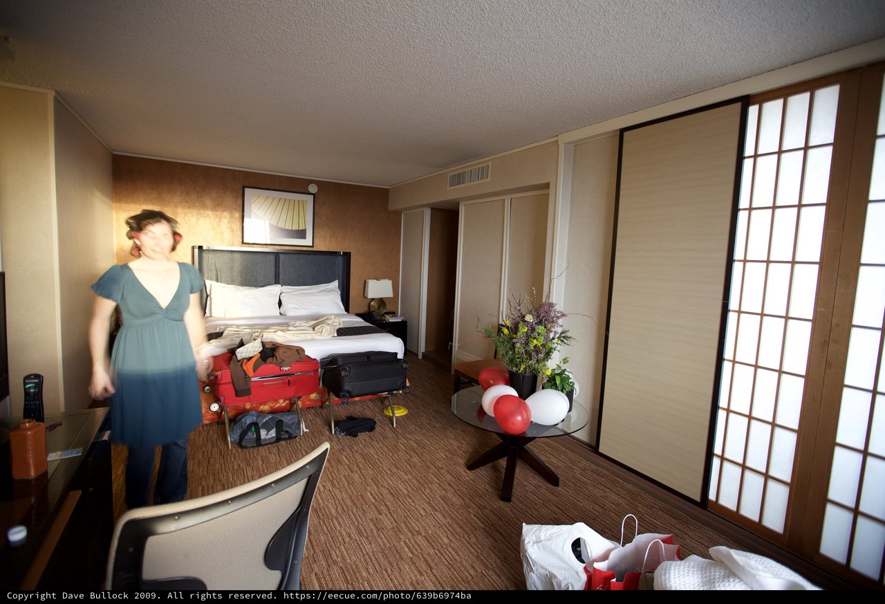 Excited Woman Arrives at Decorated Hotel Room