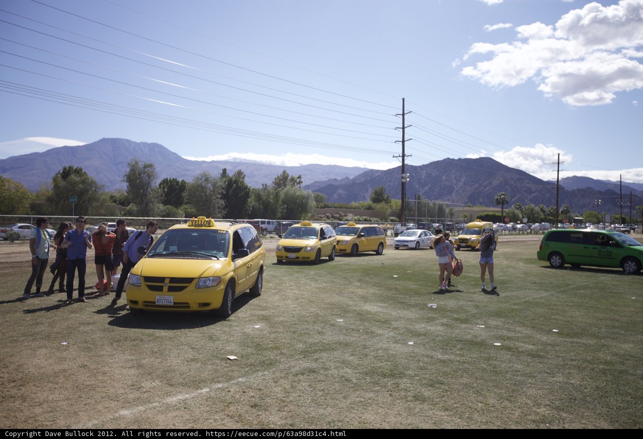 Group of People and a Yellow Taxi