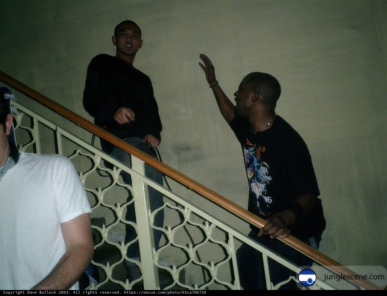 Three Men on Stairway, One Pointing