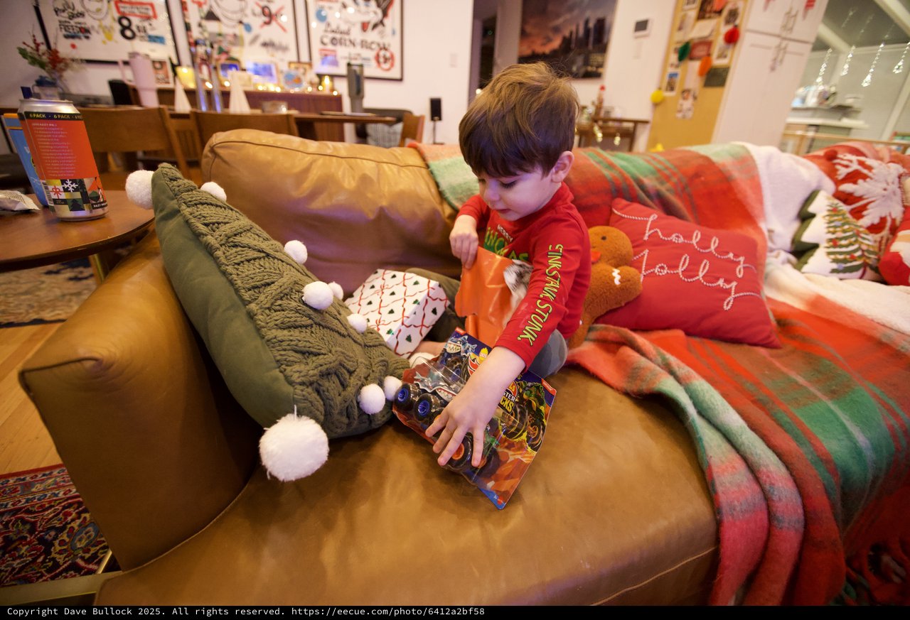 Christmas Morning Joy: Child Opening Holiday Gifts