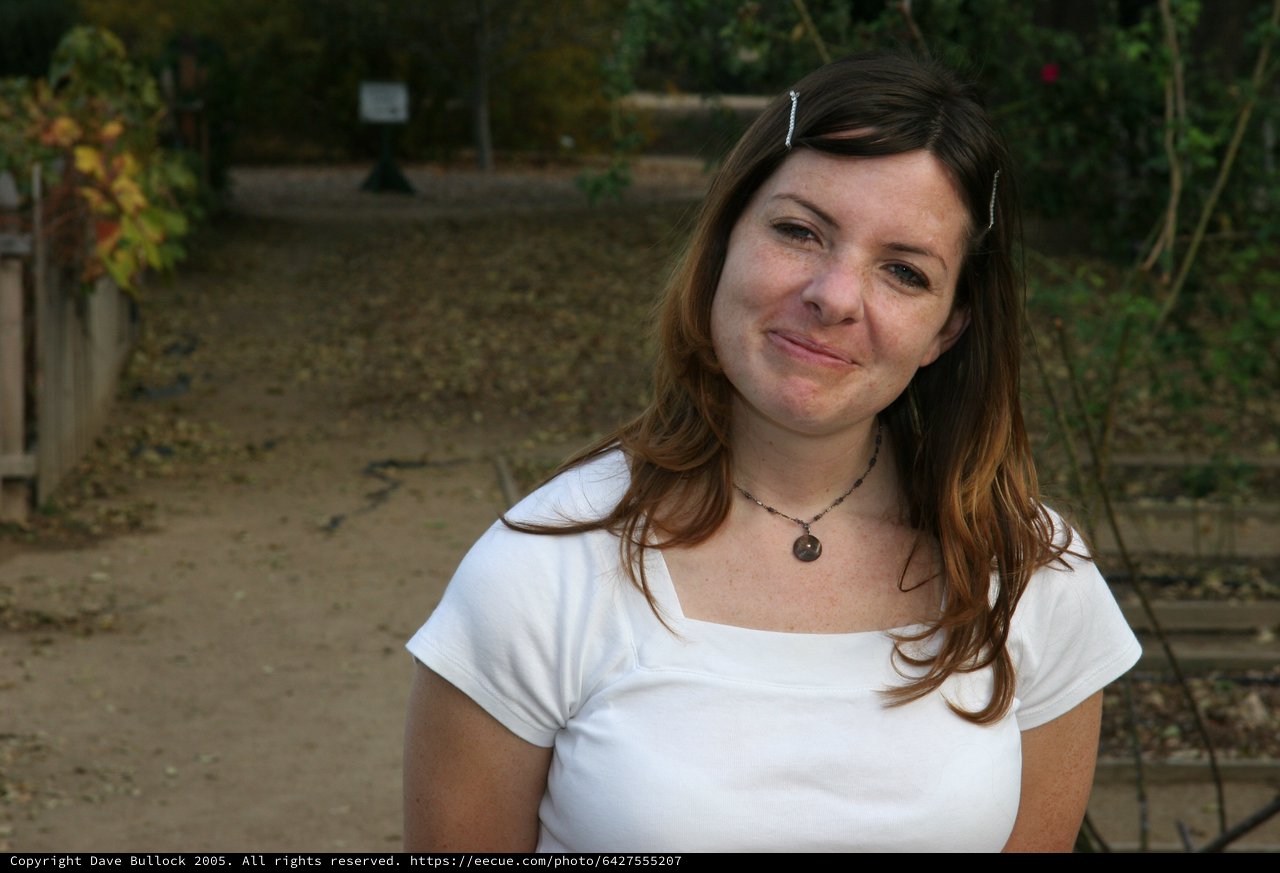 Young Woman Smiling Outdoors in Autumn Garden
