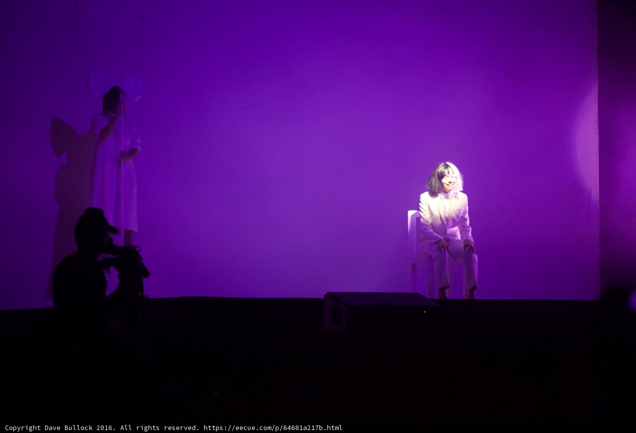 White-Clothed Woman Amidst Purple Lights