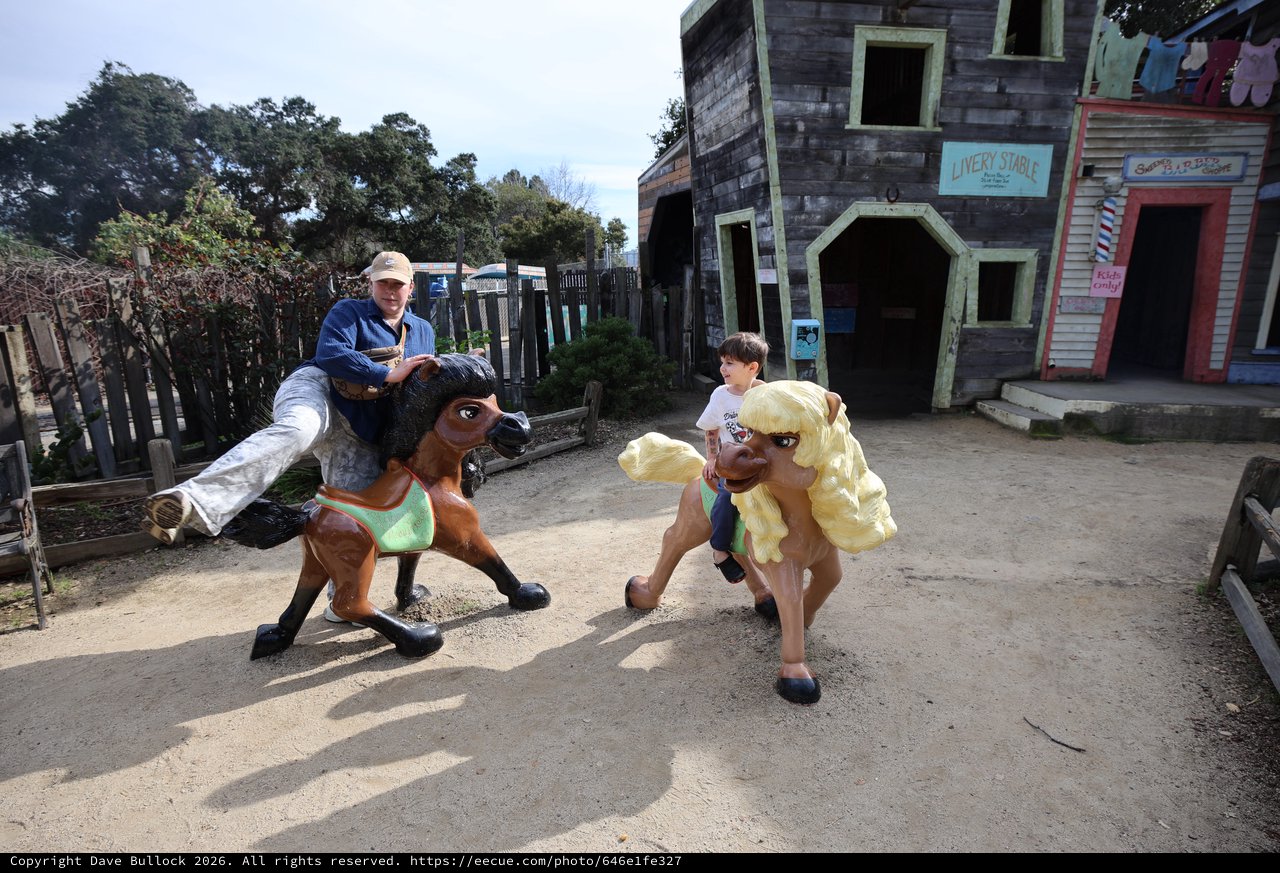 Children Riding Giant Toy Horses at Western Theme Park