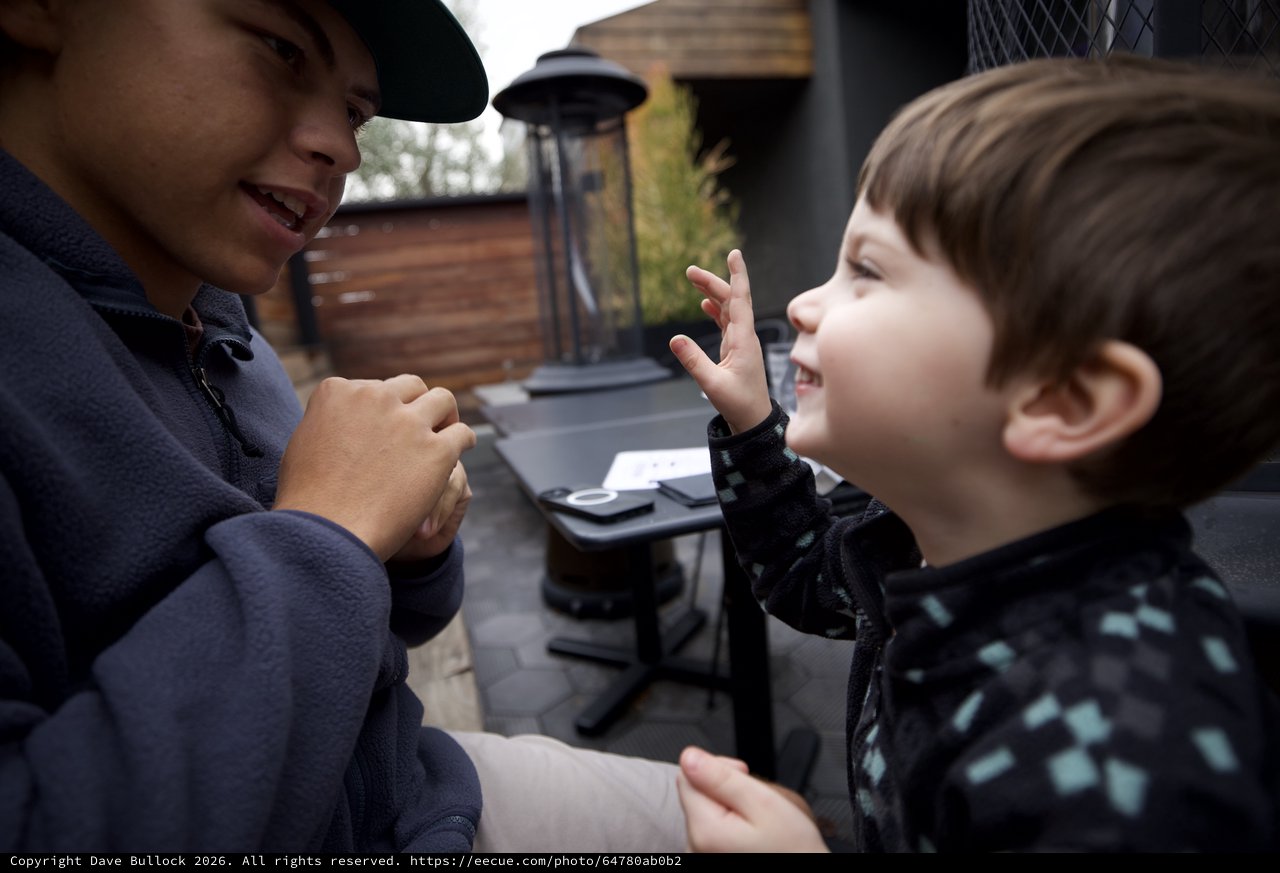 Joyful Outdoor Conversation Between Adult and Child