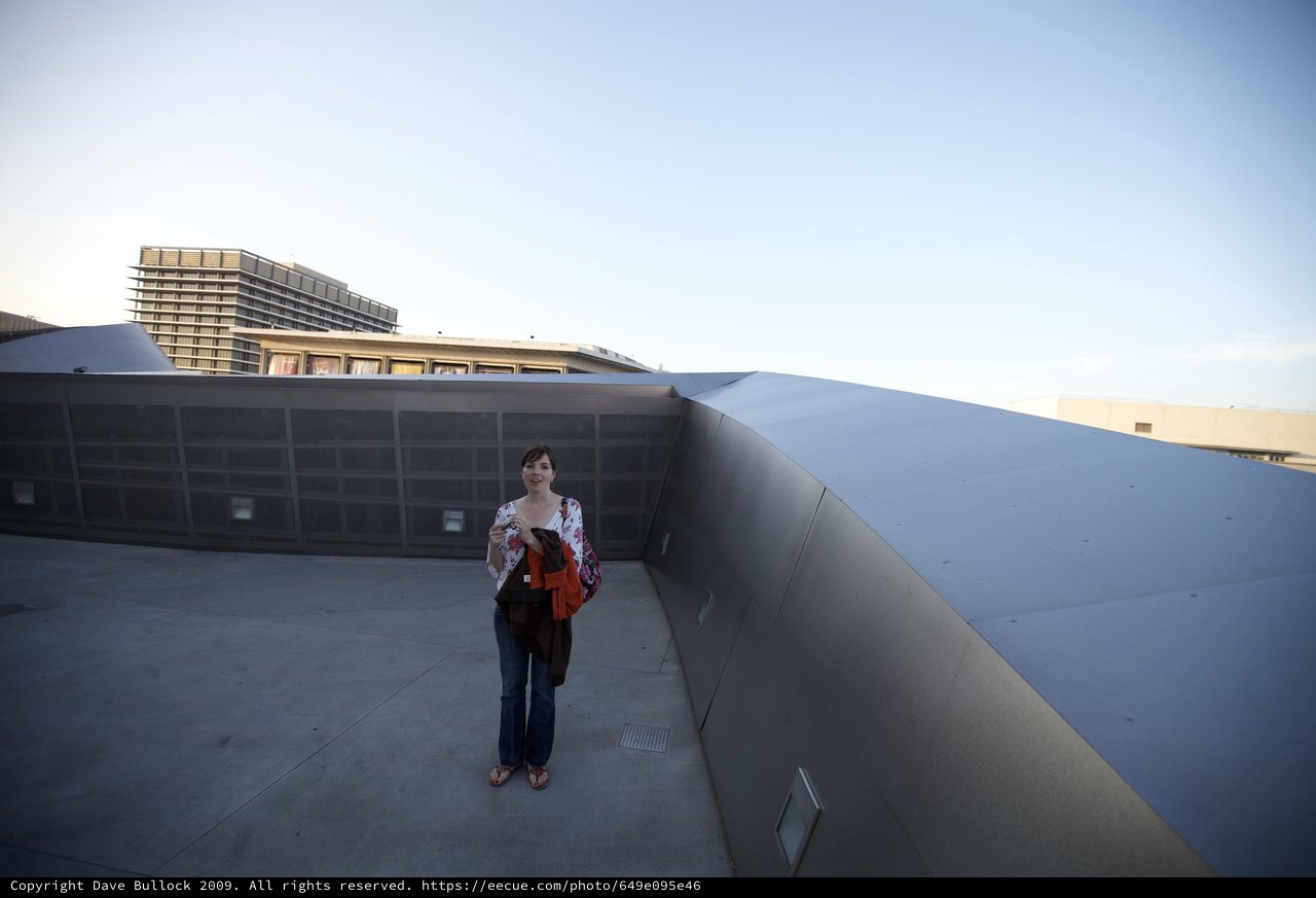 Woman Poses on Rooftop of Iconic Modern Museum