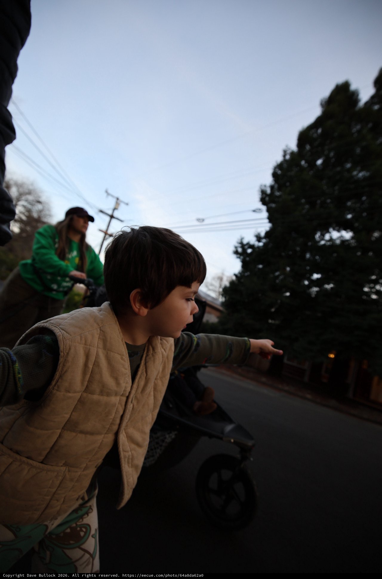 Child Points Forward on Evening Street Walk
