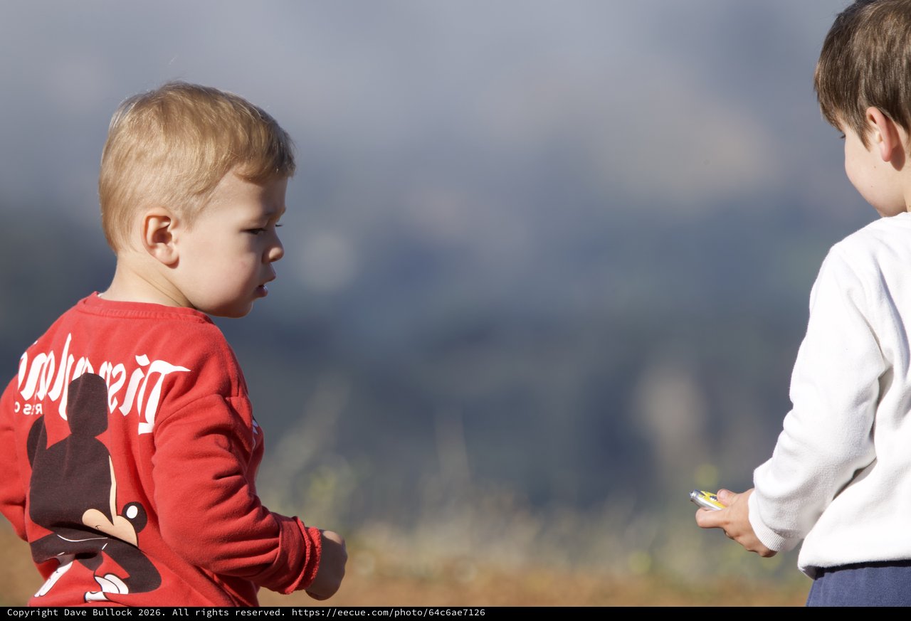 Two Young Boys in a Standoff Outdoors