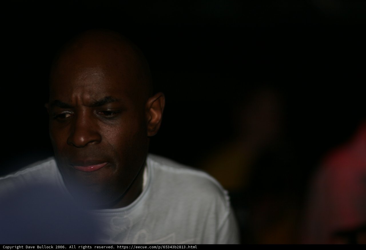 Pensive MC Q in White Shirt