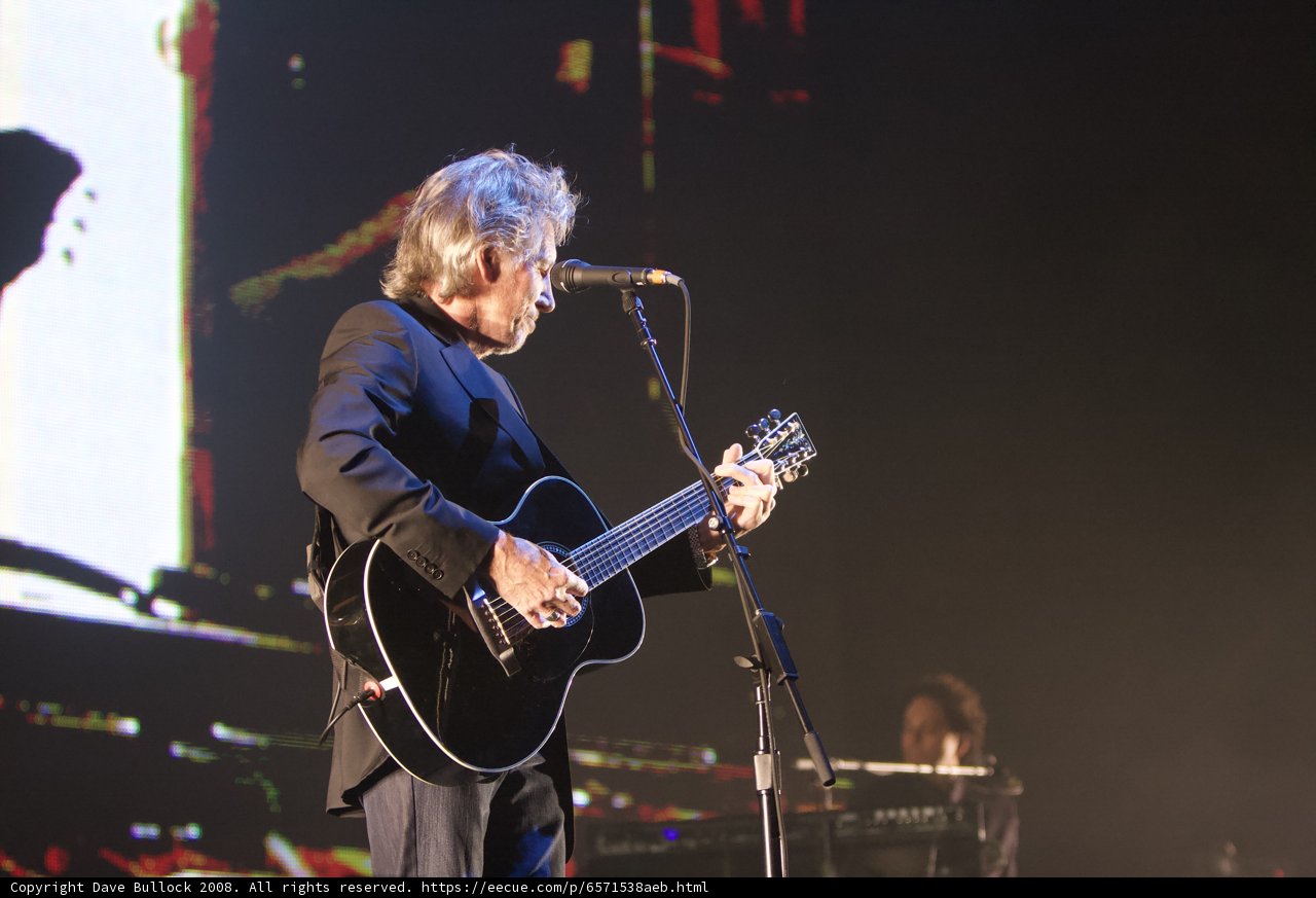 Strumming Solo: A Man with His Acoustic Guitar on Stage