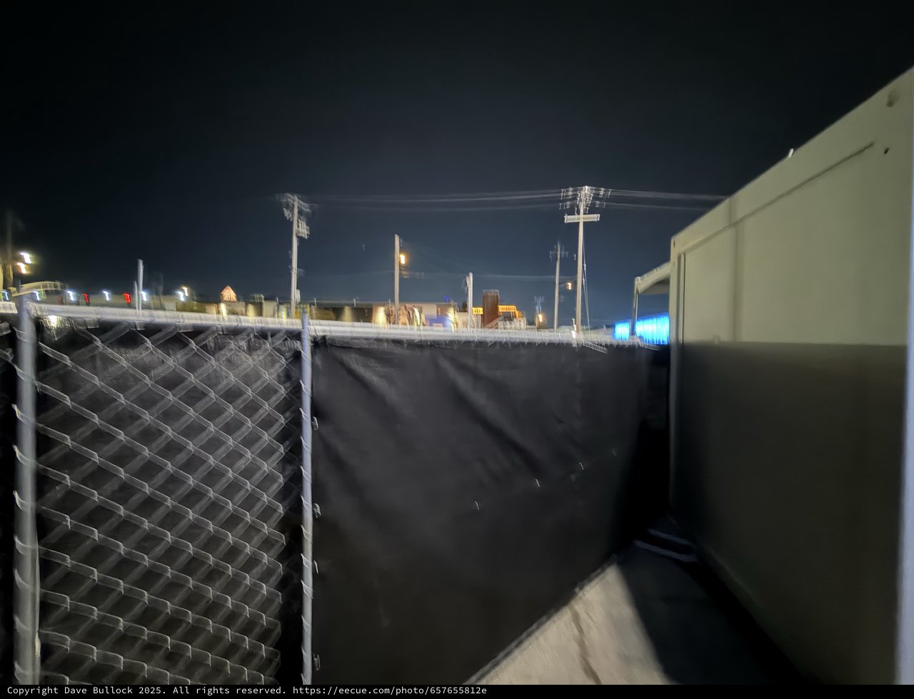 Chain Link Fence with Privacy Screen at Night