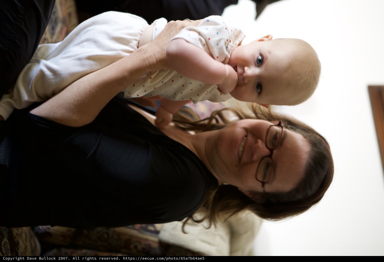 Joyful Mother Holds Curious Baby Indoors