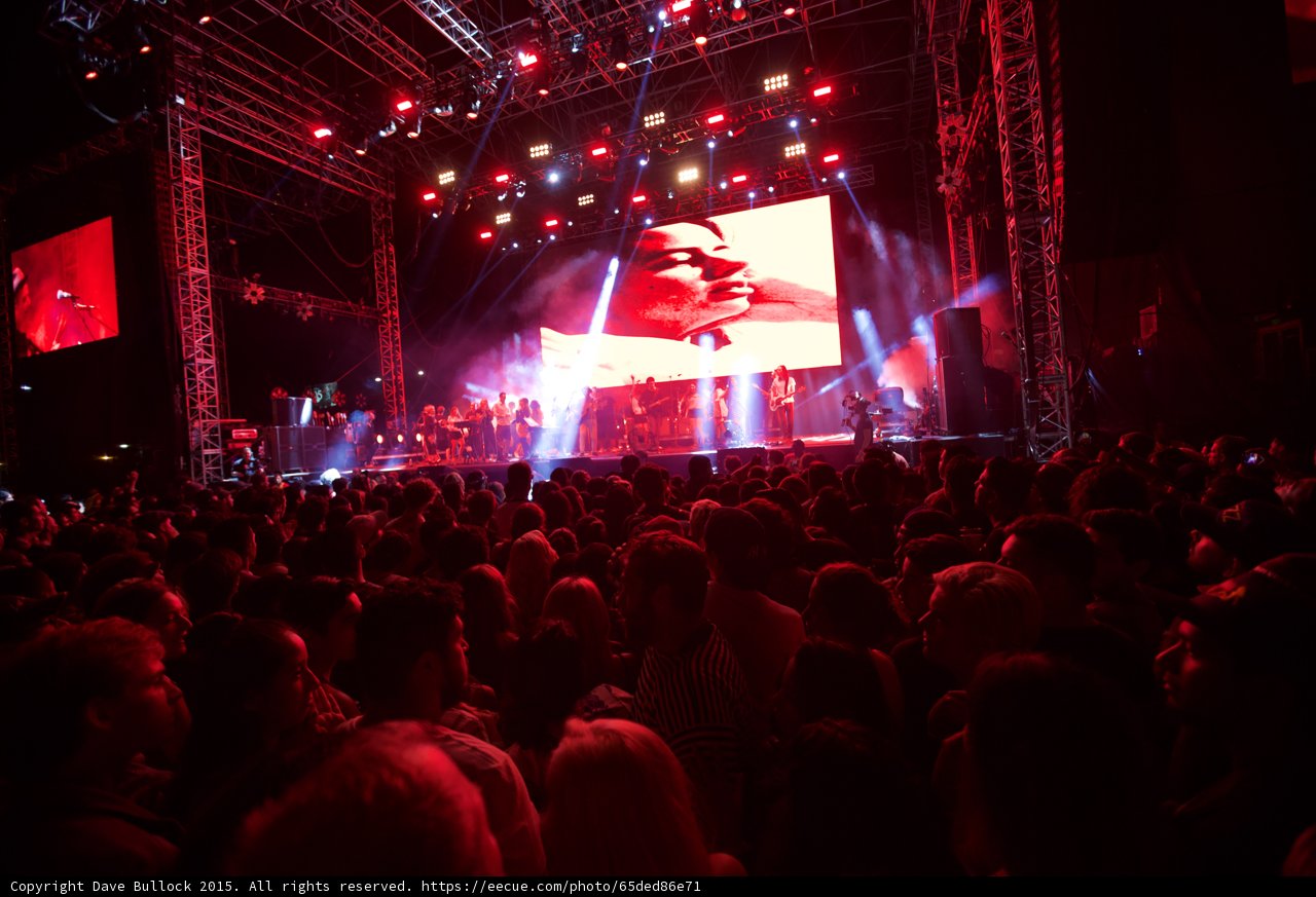 Belle and Sebastian Wide Stage Video Screen Romantic Red Lighting Spotlight Beams Full Crowd
