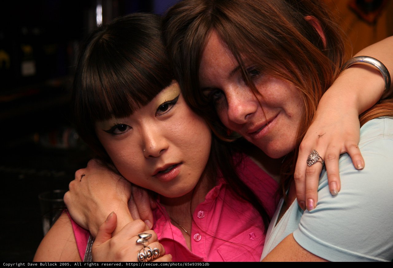 Two Friends Share a Close Embrace at Night