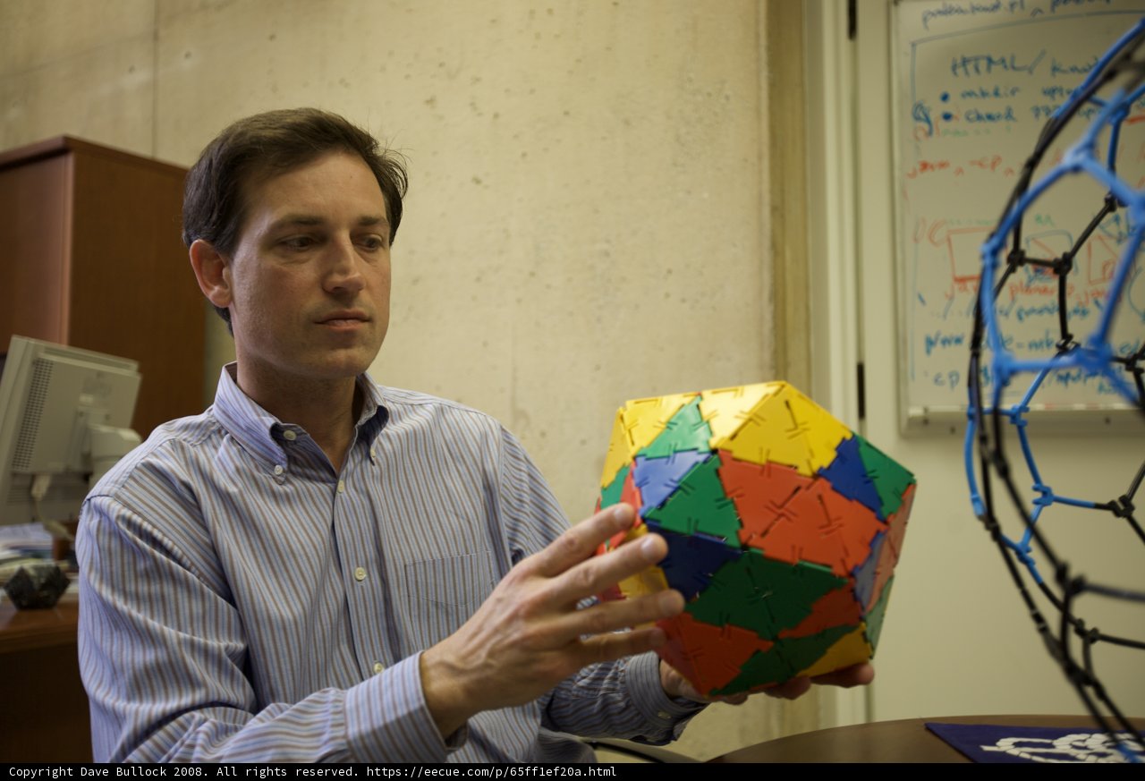 Colorful Sphere in the Hands of a Man