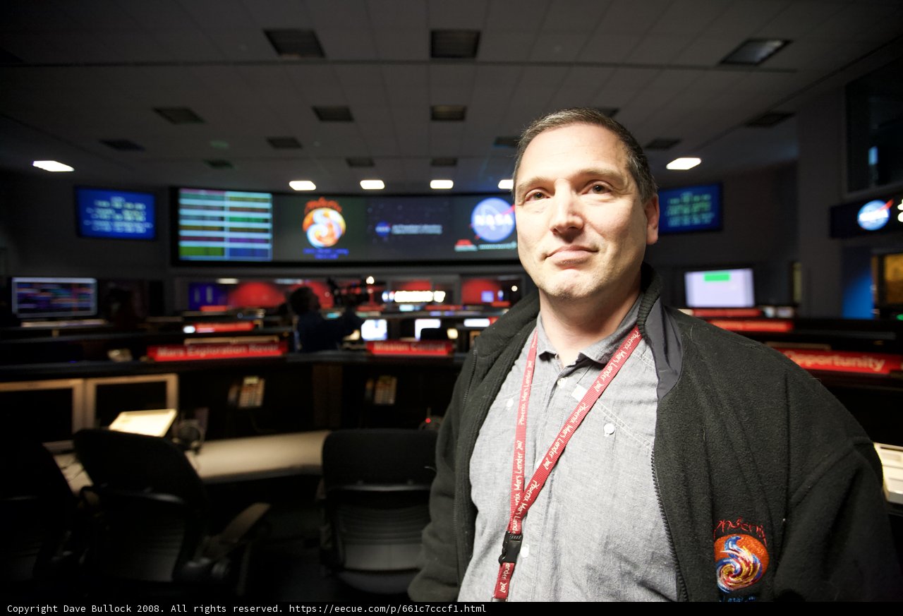 Man with 5 Monitor Setup for Mars Lander Mission