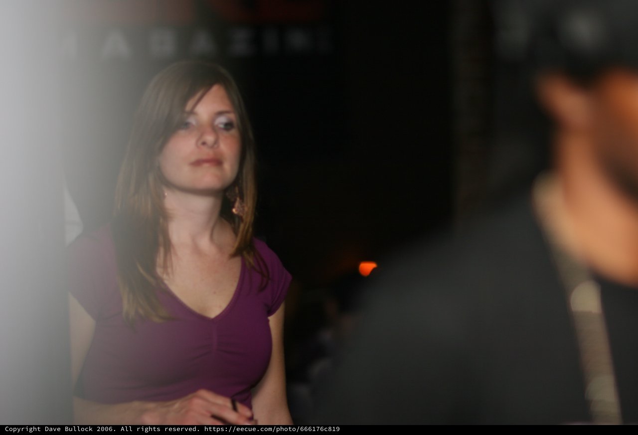 Young Woman in Purple at Dimly Lit Nightclub