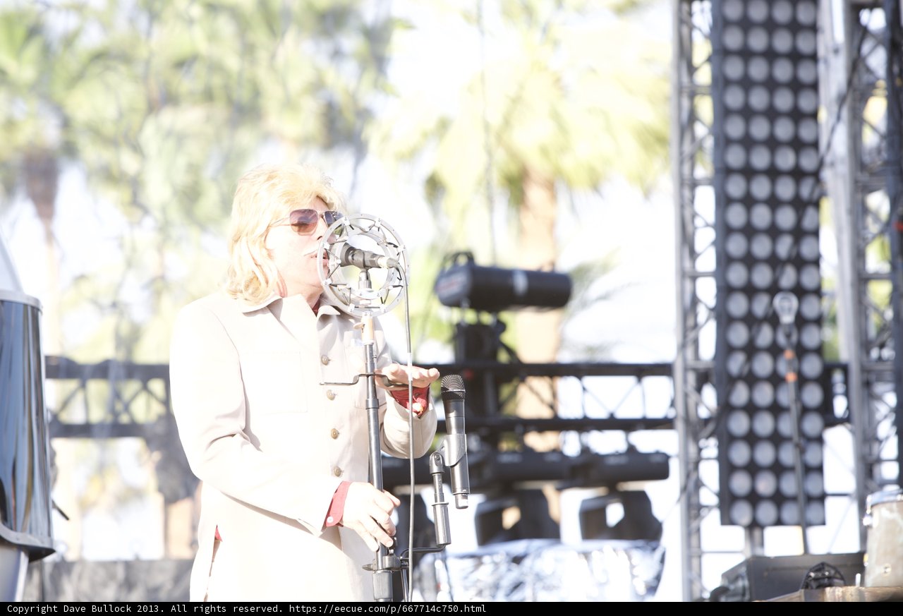 Man on Stage with Two Microphones