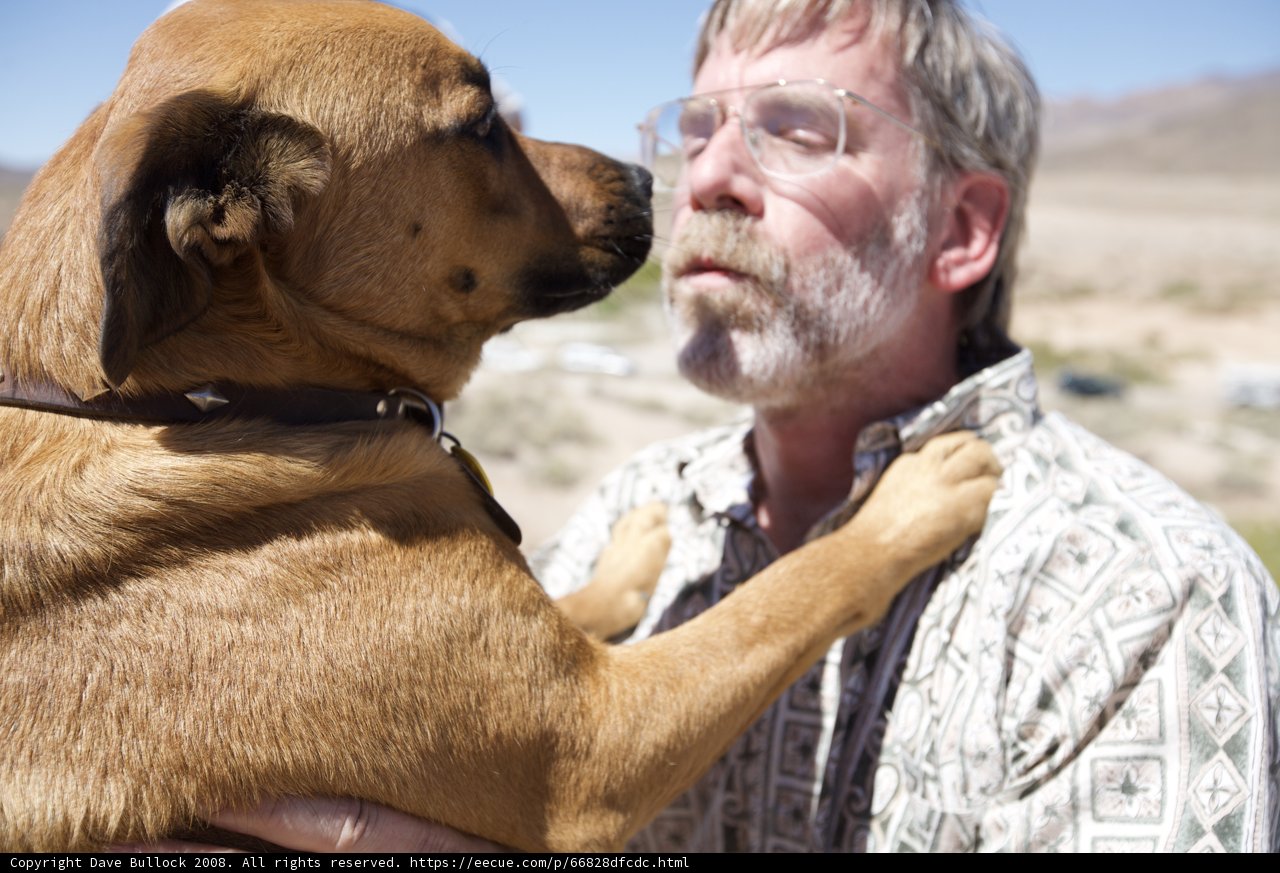 Man and his furry companion under the desert sun