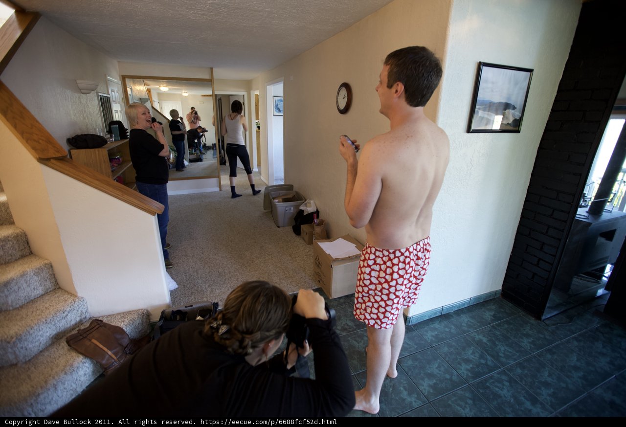 Man in Polka Dot Swimsuit Poses in Wedding Venue Hallway