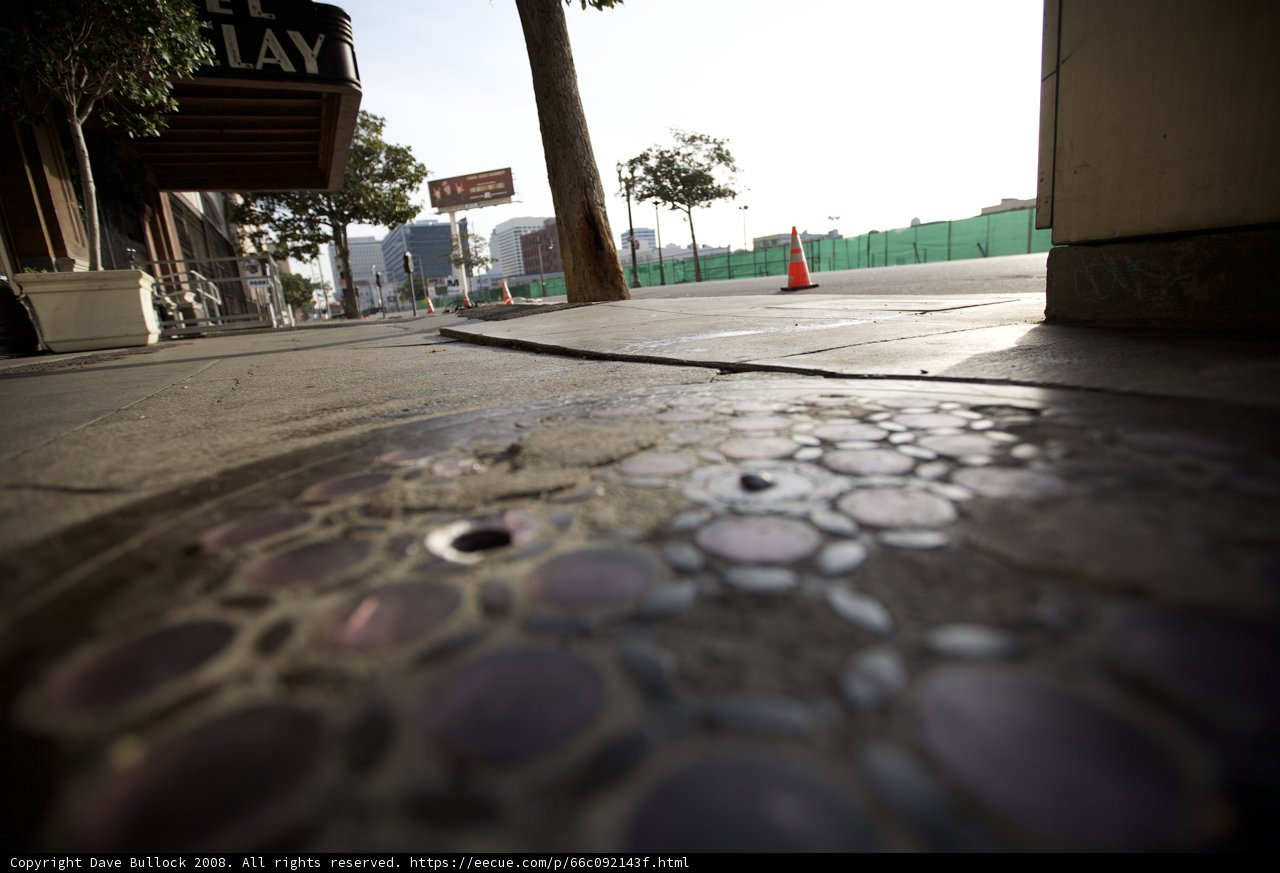Manhole Cover on City Sidewalk