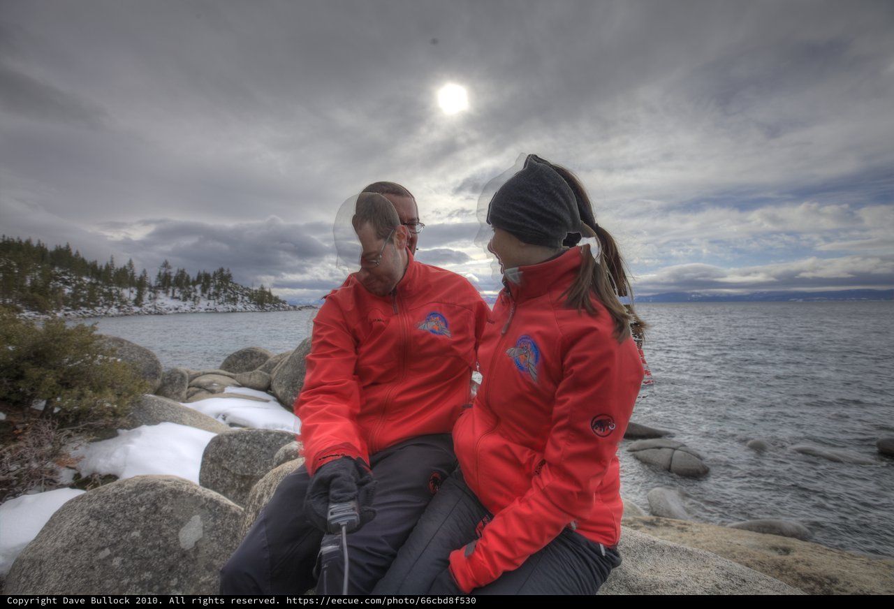 Couple Resting on Rocky Lake Tahoe Shore in Winter
