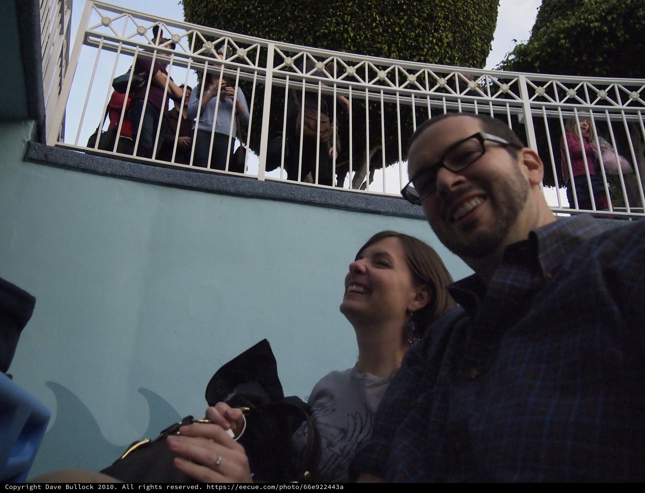 Playful Low-Angle Selfie on Urban Steps Below Railing