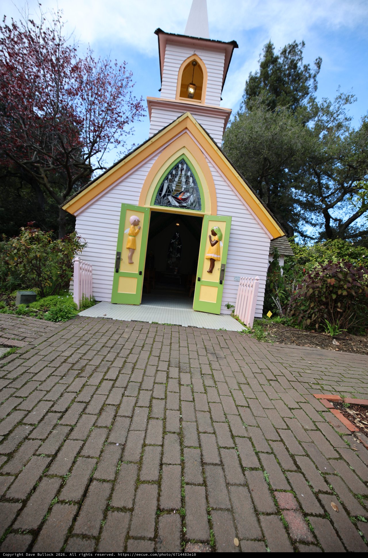 Whimsical Chapel Entrance with Colorful Doors and Steeple