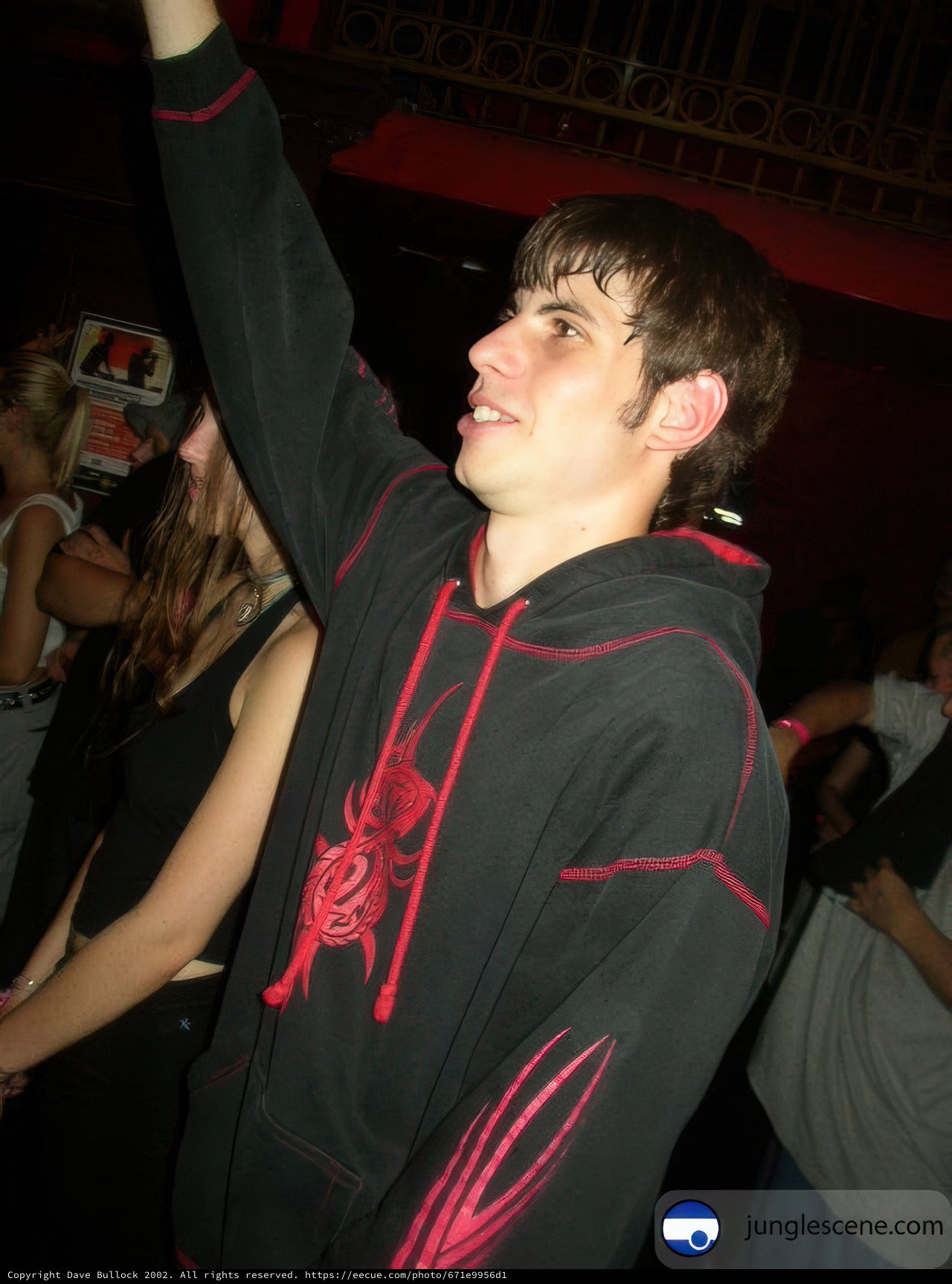 Man in Black Hoodie at Nightclub