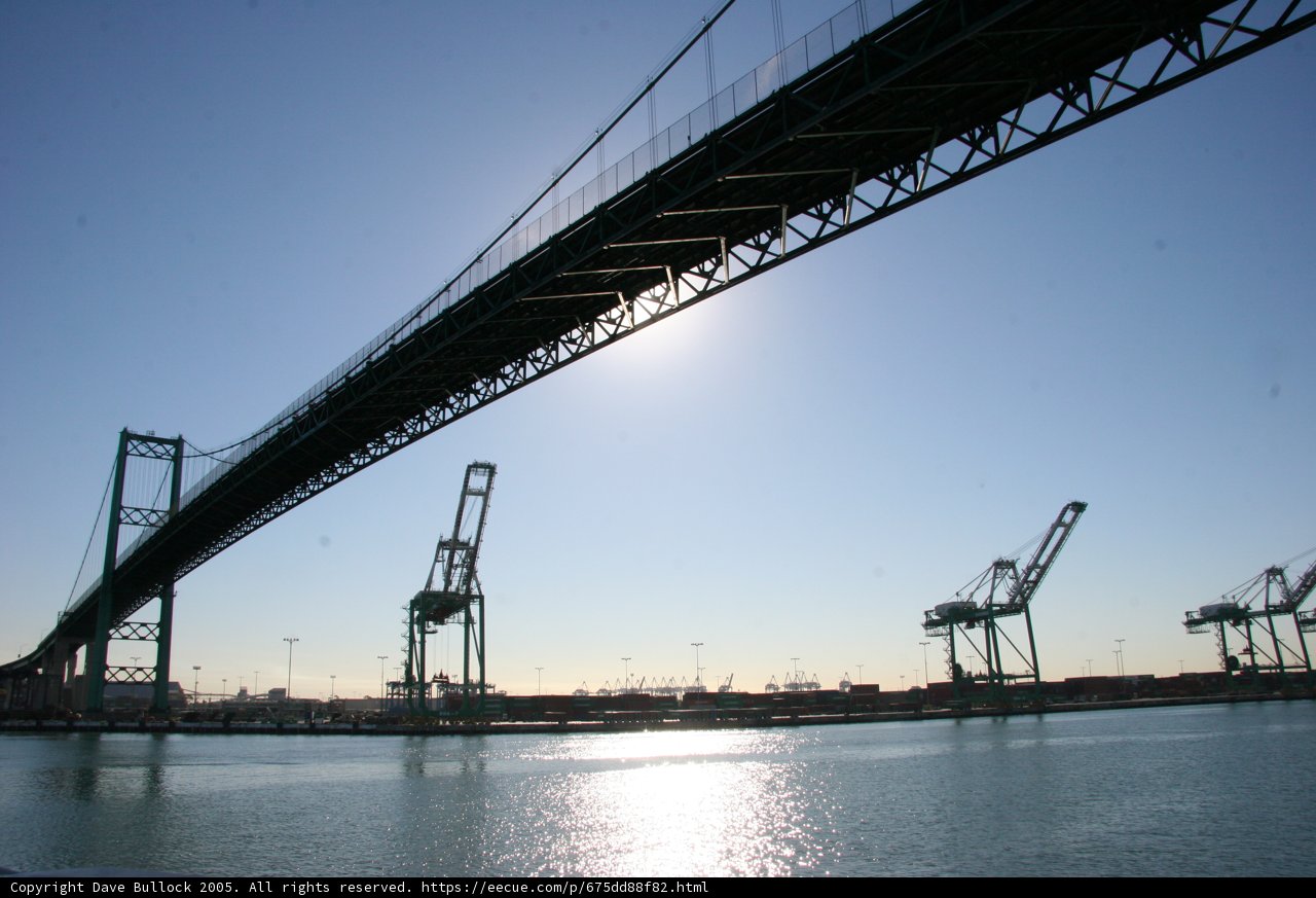 Arch Bridge over Lake with Cranes and Ships