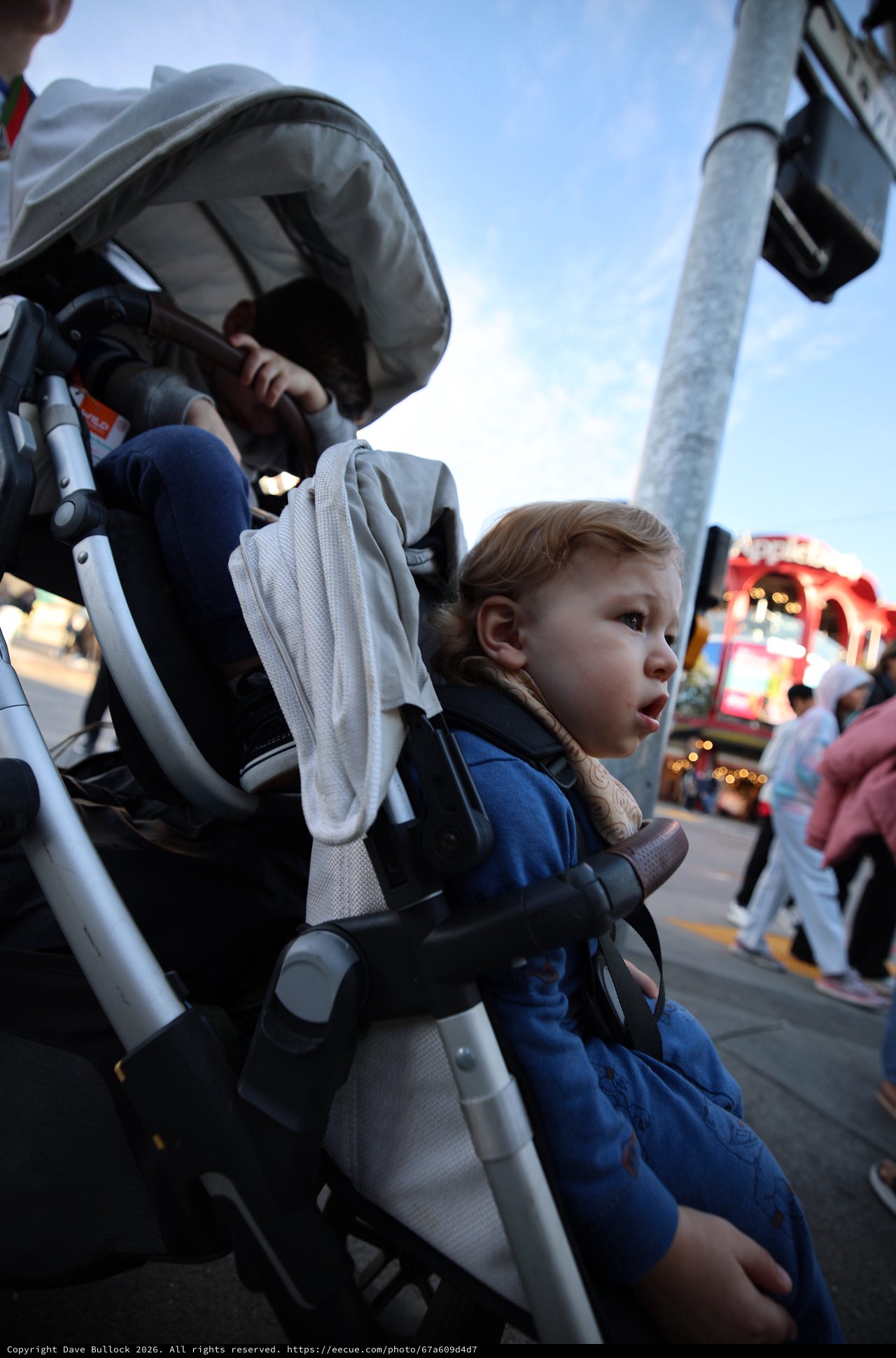 Young Child Watches Carnival Lights at Twilight Fair