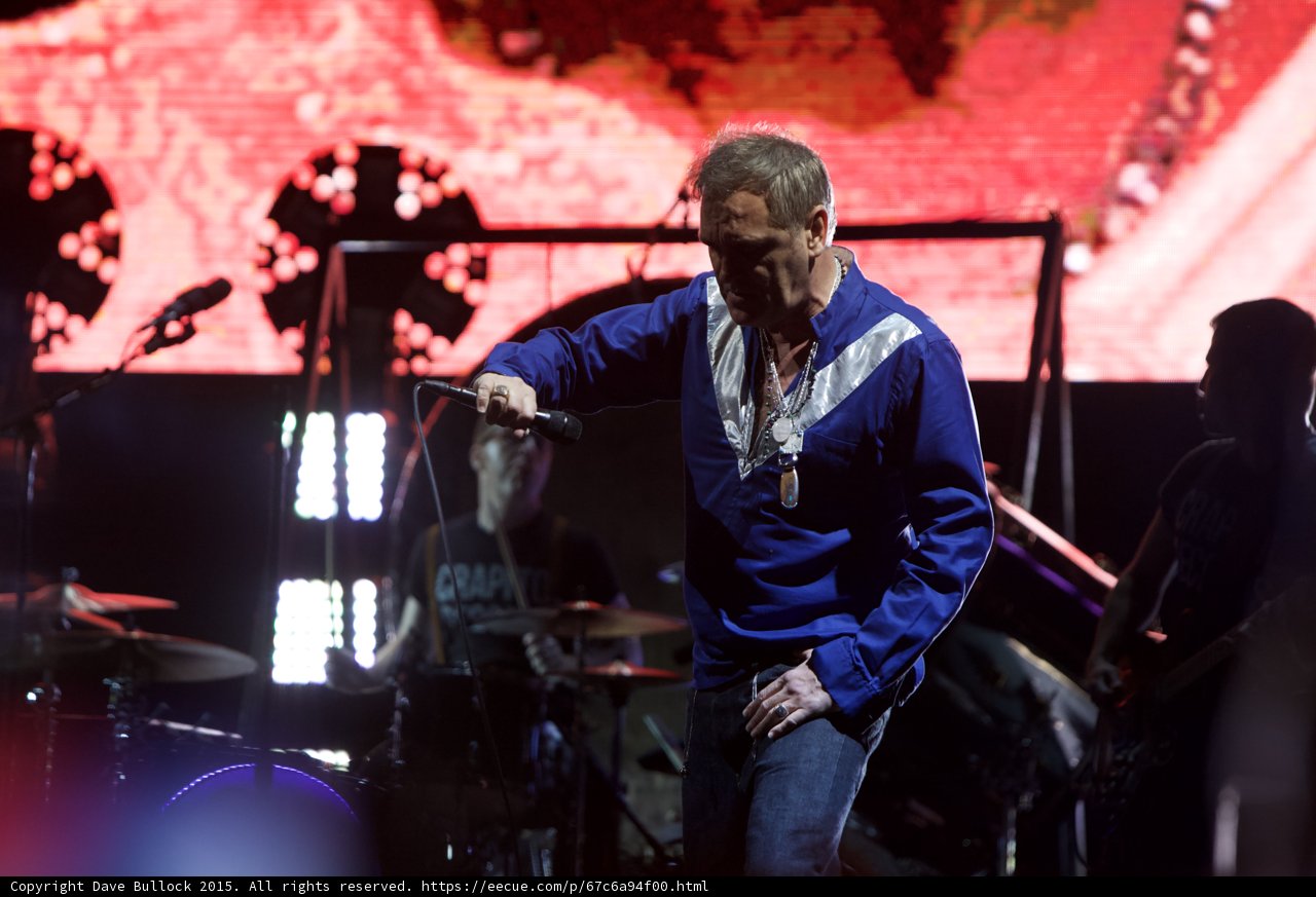 Morrissey Holding Mic Looking Down Blue Shirt LED Panel Green Drummer Capitol Records Bassist Circular Lights