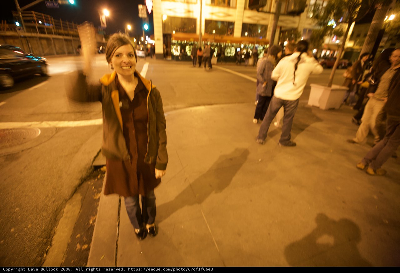 Smiling Woman Celebrates on City Street at Night